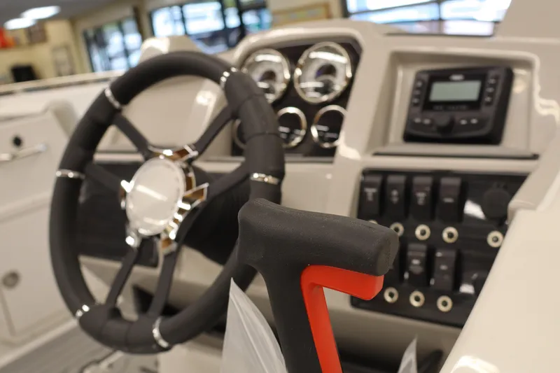 Slide: The Image of 2026 Starcraft SVX 191 OB boat dashboard with steering wheel and control panel. - 6