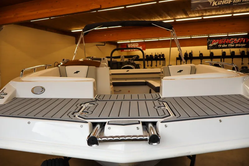 Slide: The Image of 2026 Starcraft SVX 191 OB boat with sleek deck design in showroom setting. - 7