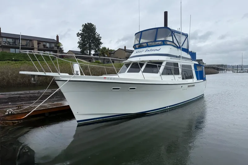The Image of 1979 Uniflite 37 Coastal Cruiser docked on a cloudy day. - 0