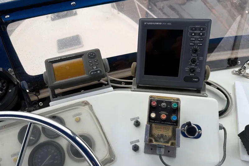 Slide: The Image of Control panel of a 1979 Uniflite 37 Coastal Cruiser with navigation equipment. - 15