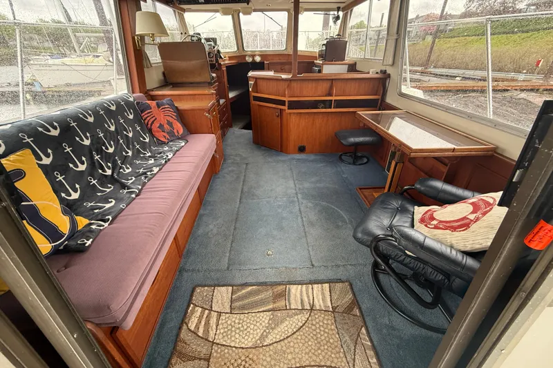 Slide: The Image of Interior of 1979 Uniflite 37 Coastal Cruiser with nautical-themed decor and wooden furnishings. - 18