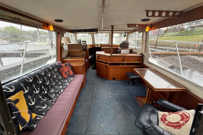 Slide: The Image of Interior of a 1979 Uniflite 37 Coastal Cruiser with nautical-themed decor. - 19