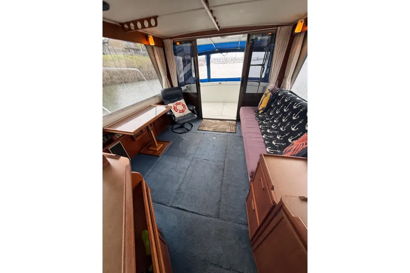 Slide: The Image of Interior of 1979 Uniflite 37 Coastal Cruiser with cozy seating and nautical decor. - 22