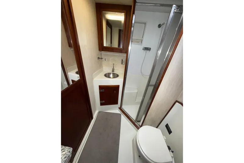 Slide: The Image of 1979 Uniflite 37 Coastal Cruiser bathroom with shower, sink, and toilet. - 29