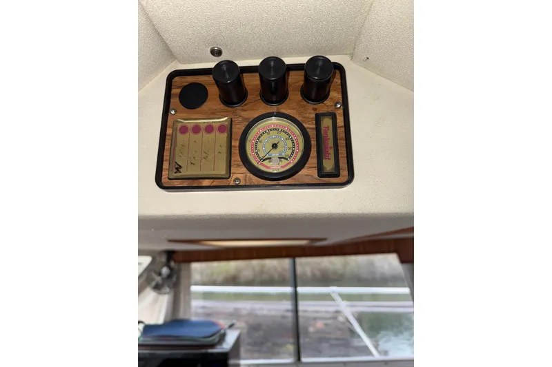 Slide: The Image of 1979 Uniflite 37 Coastal Cruiser dashboard with gauges and controls. - 31