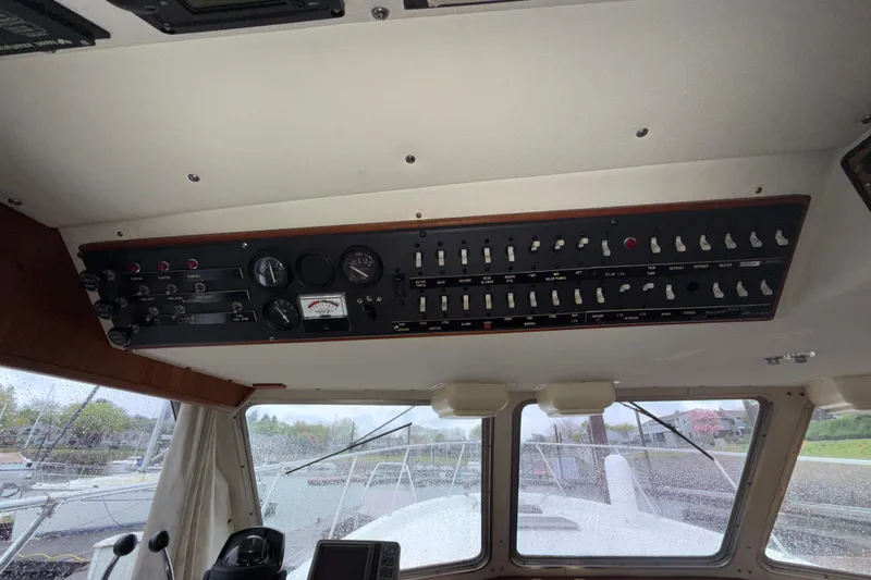 Slide: The Image of 1979 Uniflite 37 Coastal Cruiser control panel with gauges and switches, interior view. - 32
