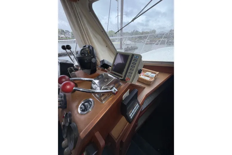 Slide: The Image of 1979 Uniflite 37 Coastal Cruiser helm with navigation equipment and controls. - 34