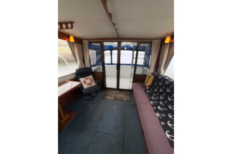 Slide: The Image of Interior of 1979 Uniflite 37 Coastal Cruiser with nautical-themed decor and seating. - 35
