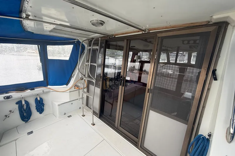 Slide: The Image of 1979 Uniflite 37 Coastal Cruiser interior with blue canopy and sliding glass doors. - 4