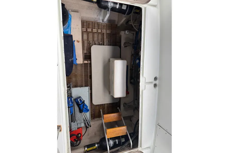 Slide: The Image of 1979 Uniflite 37 Coastal Cruiser engine compartment with tools and equipment. - 5