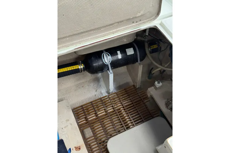 Slide: The Image of Engine compartment of 1979 Uniflite 37 Coastal Cruiser with visible components and grating. - 7