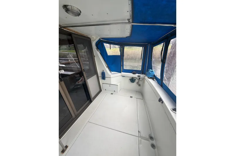 Slide: The Image of 1979 Uniflite 37 Coastal Cruiser interior with blue canopy and sliding glass door. - 9