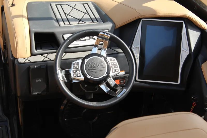 Slide: The Image of Steering wheel and dashboard of 2022 Tigé 23ZX boat with touchscreen display. - 11