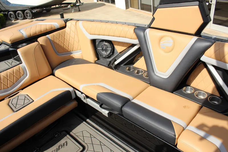 Slide: The Image of Luxurious interior of 2022 Tigé 23ZX boat with tan and black seating, cup holders, and speaker. - 12