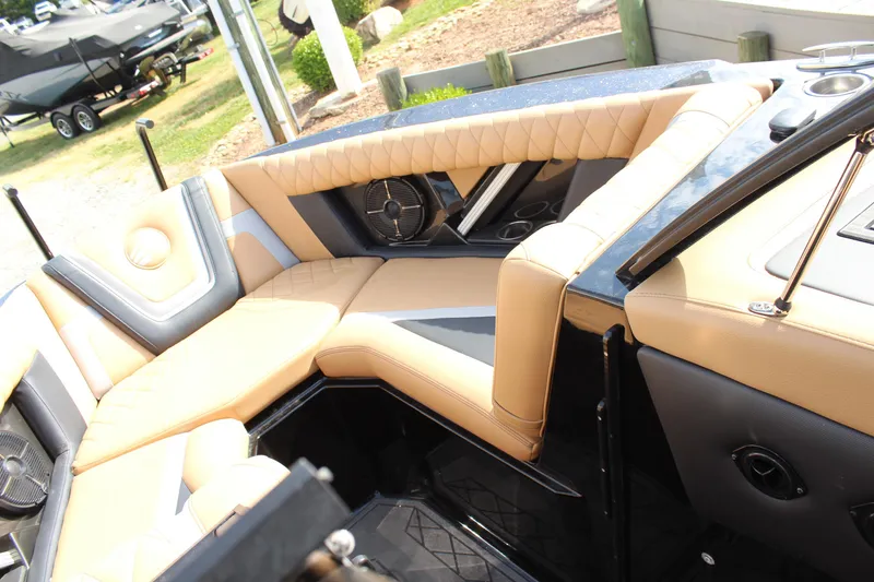 Slide: The Image of Luxurious interior of 2022 Tigé 23ZX boat with tan leather seating. - 16