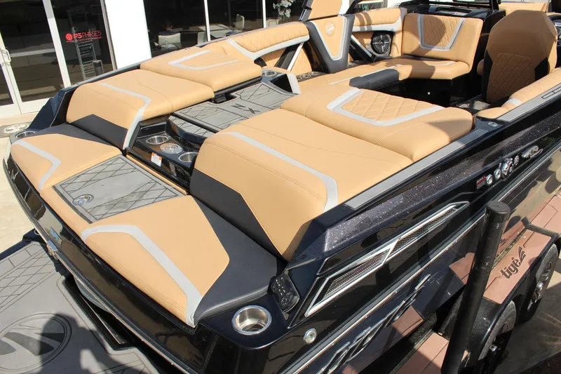 Slide: The Image of 2022 Tigé 23ZX boat interior with tan and gray seating, showcasing luxury design. - 7