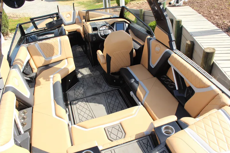 Slide: The Image of 2022 Tigé 23ZX boat interior with luxurious tan seating and modern dashboard. - 8
