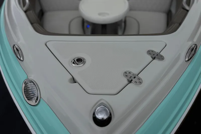 Slide: The Image of 2022 Crownline 220 SS SURF boat bow with teal accents and stainless steel fixtures. - 11