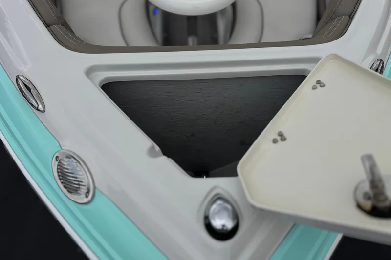 Slide: The Image of 2022 Crownline 220 SS SURF boat storage compartment with open hatch, showcasing interior details. - 12