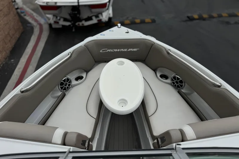 Slide: The Image of 2022 Crownline 220 SS SURF boat interior with seating and table, showcasing luxury design. - 14
