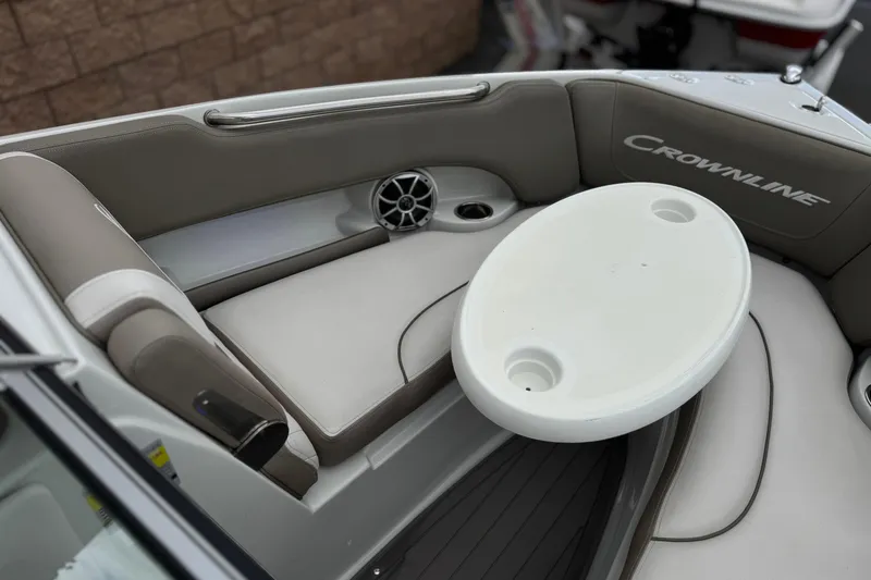 Slide: The Image of Interior of 2022 Crownline 220 SS SURF boat with seating and table. - 15