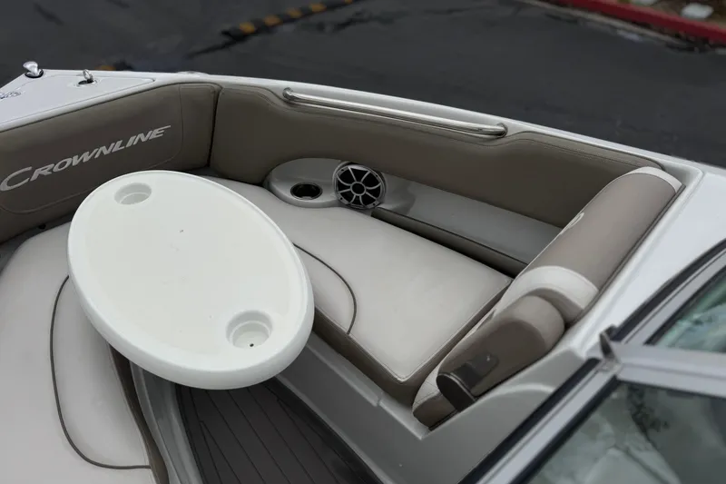 Slide: The Image of Interior of 2022 Crownline 220 SS SURF boat with seating and table. - 16