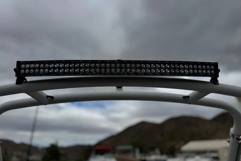 Slide: The Image of LED light bar on 2022 Crownline 220 SS SURF boat against cloudy sky. - 18