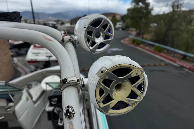 Slide: The Image of Speakers mounted on a 2022 Crownline 220 SS SURF boat, with a scenic background. - 20