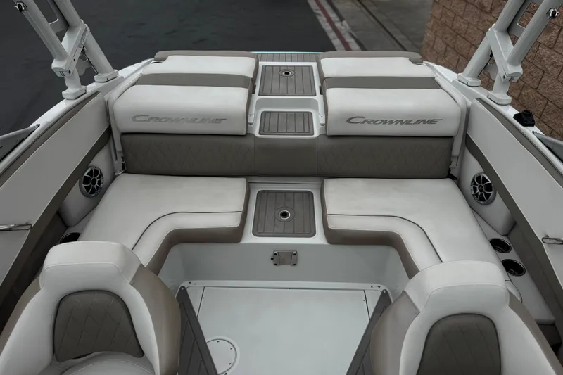 Slide: The Image of 2022 Crownline 220 SS SURF boat interior with cushioned seating and storage compartments. - 21