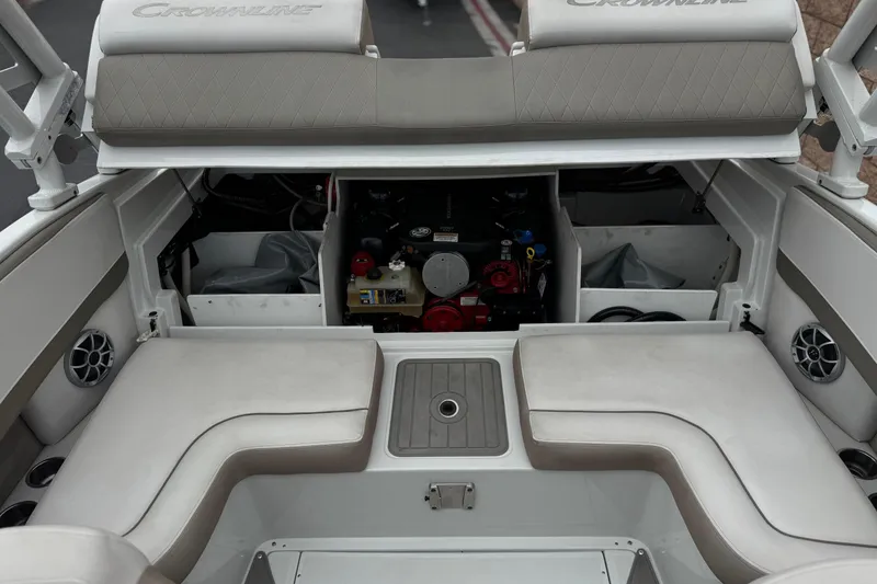 Slide: The Image of 2022 Crownline 220 SS SURF boat interior with open engine compartment and seating area. - 22
