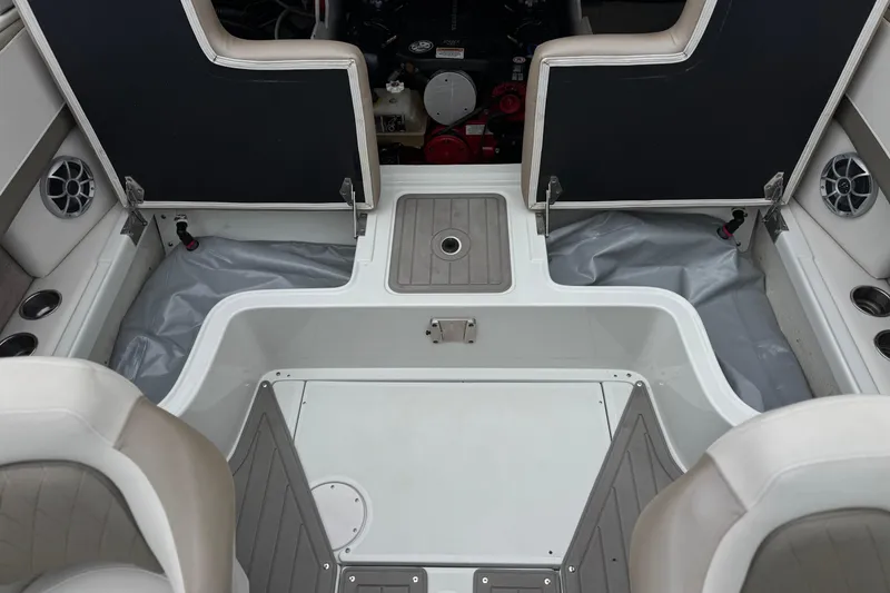 Slide: The Image of 2022 Crownline 220 SS SURF boat interior with open engine compartment and seating area. - 26
