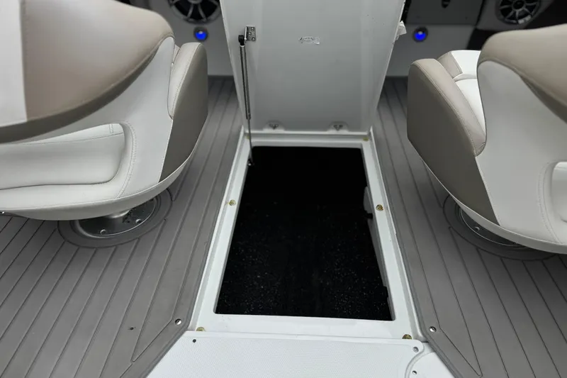 Slide: The Image of 2022 Crownline 220 SS SURF boat interior with open storage compartment and seating. - 27