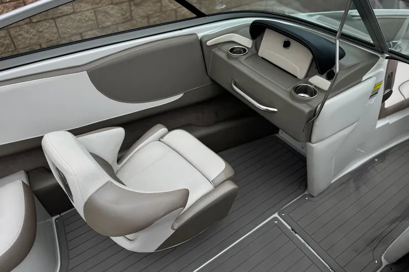 Slide: The Image of 2022 Crownline 220 SS SURF boat interior with gray and white seating and dashboard. - 28
