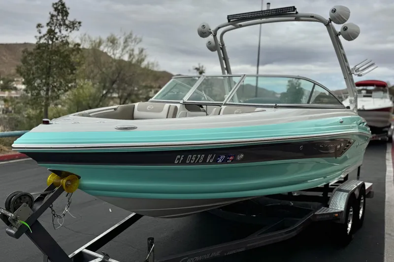 Slide: The Image of 2022 Crownline 220 SS SURF boat on trailer, parked outdoors. - 3