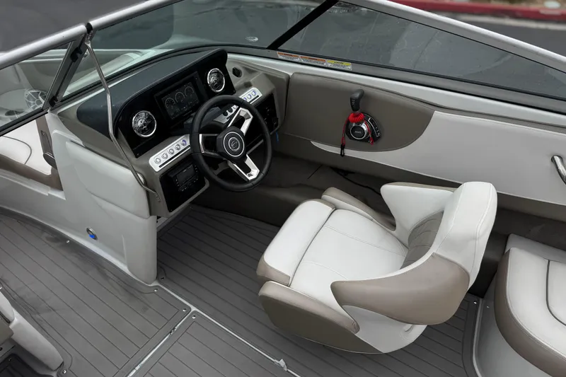 Slide: The Image of 2022 Crownline 220 SS SURF boat interior with steering wheel and dashboard controls. - 30