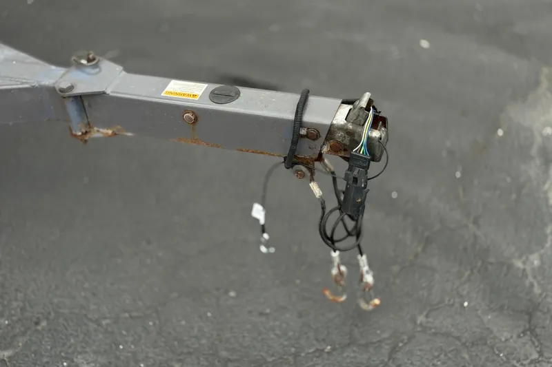 Slide: The Image of Trailer hitch with wiring for 2022 Crownline 220 SS SURF on asphalt surface. - 38