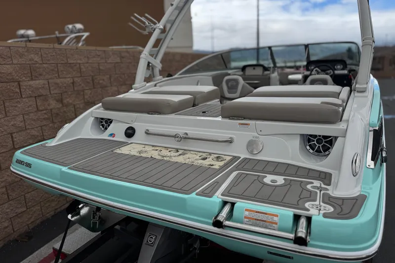 Slide: The Image of 2022 Crownline 220 SS SURF boat with sleek design and spacious seating. - 6