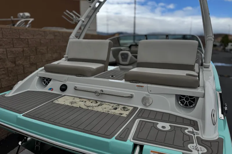 Slide: The Image of 2022 Crownline 220 SS SURF boat with sleek seating and modern design. - 7