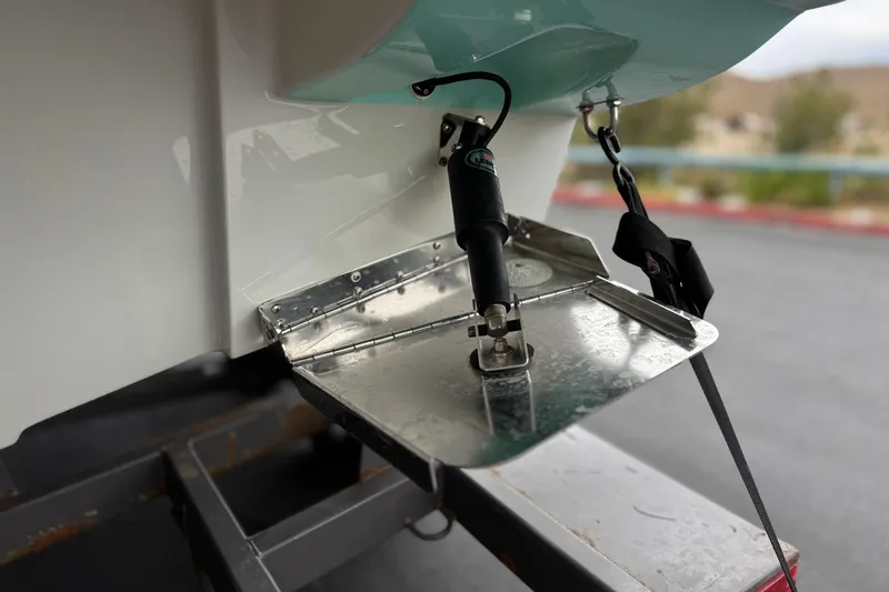 Slide: The Image of Close-up of 2022 Crownline 220 SS SURF boat's trim tab and hydraulic system. - 9