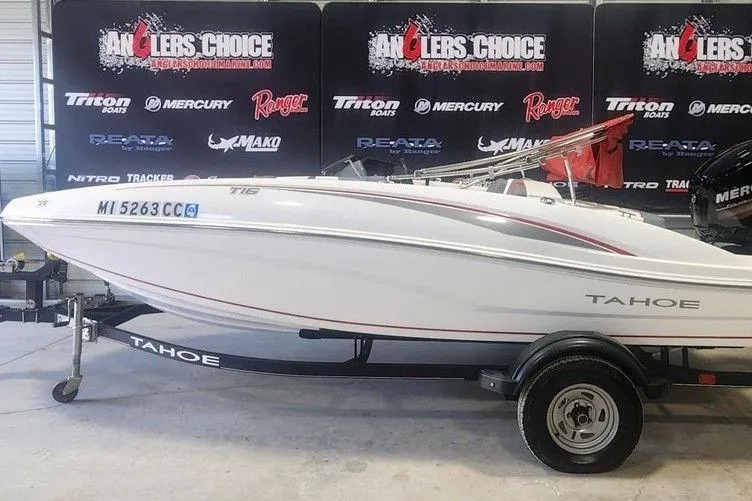 The Image of 2022 Tahoe T16 boat on trailer, displayed indoors at Anglers Choice event. - 1