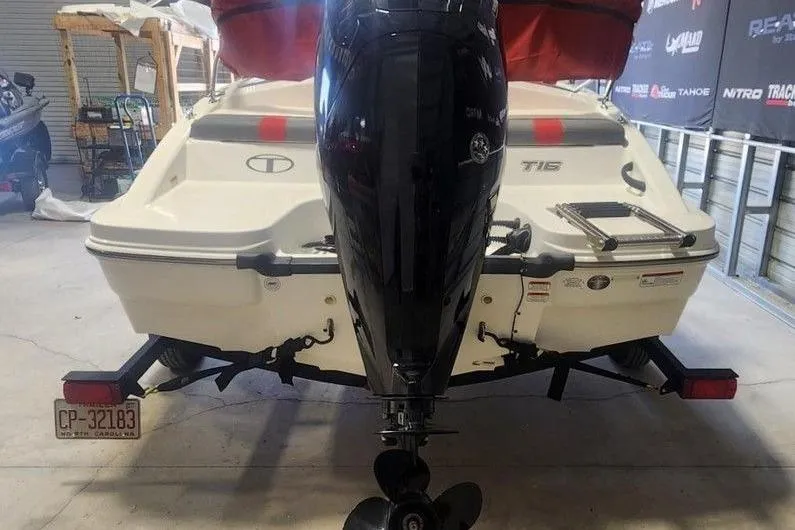 Slide: The Image of 2022 Tahoe T16 boat with outboard motor in a garage setting. - 6