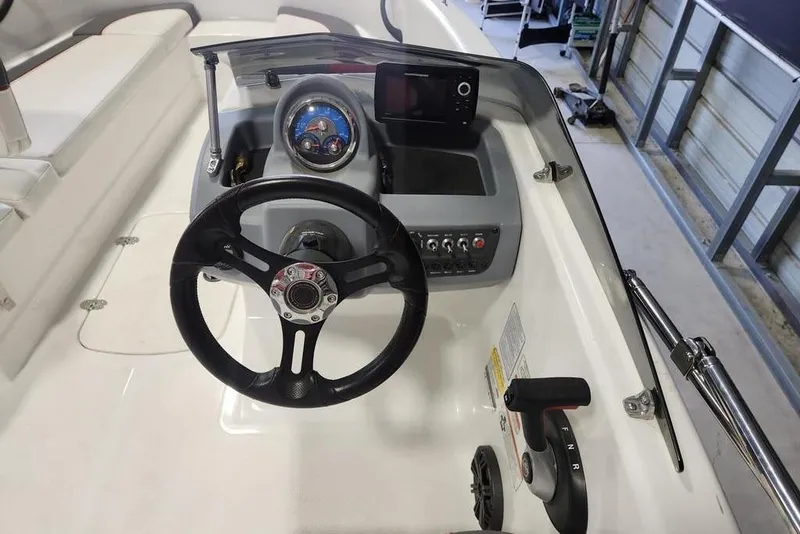 Slide: The Image of 2022 Tahoe T16 boat dashboard with steering wheel and control panel. - 9