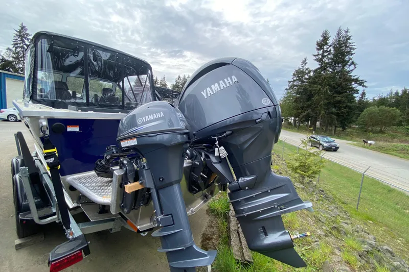 Slide: The Image of Hewescraft 190 Sea Runner 2026 with Yamaha engines parked outdoors. - 16
