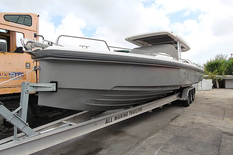 The Image of 2018 Axopar 37 Sun-Top boat on trailer, parked outdoors. - 0