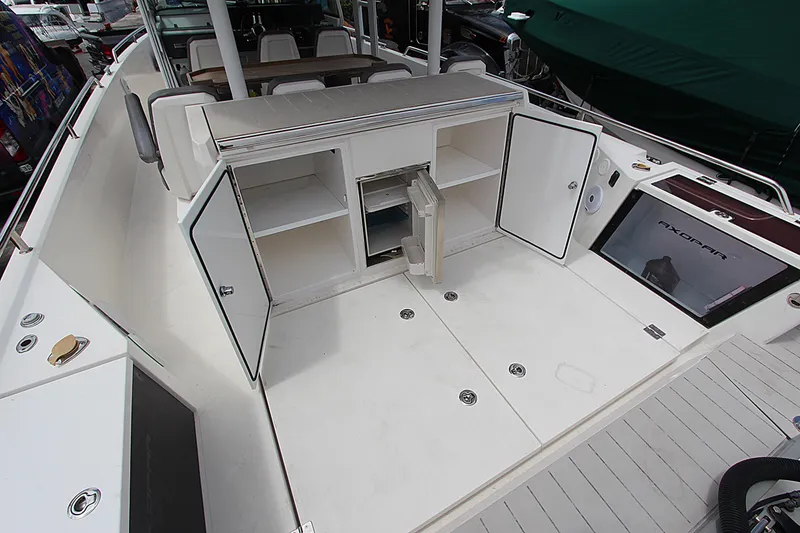 Slide: The Image of 2018 Axopar 37 Sun-Top boat deck with open storage compartments. - 11