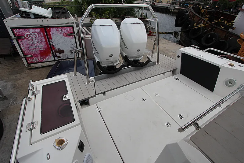 Slide: The Image of 2018 Axopar 37 Sun-Top boat with dual outboard engines at dockside. - 12