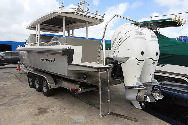 Slide: The Image of 2018 Axopar 37 Sun-Top boat with twin Mercury 350 engines on a trailer. - 15