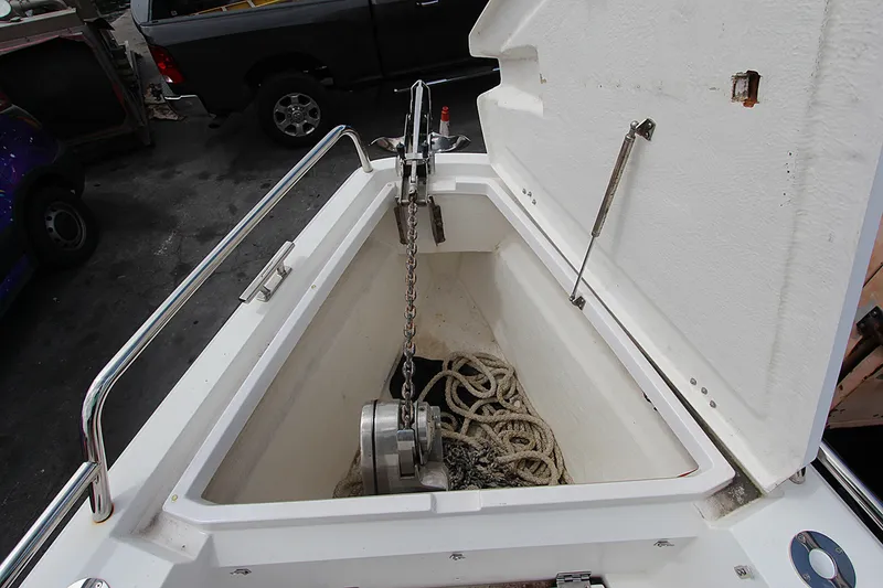 Slide: The Image of Anchor storage compartment on a 2018 Axopar 37 Sun-Top boat, featuring rope and chain. - 2
