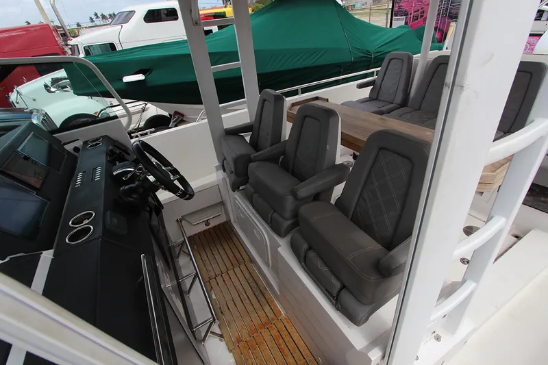 Slide: The Image of 2018 Axopar 37 Sun-Top boat interior with sleek seating and modern dashboard. - 4