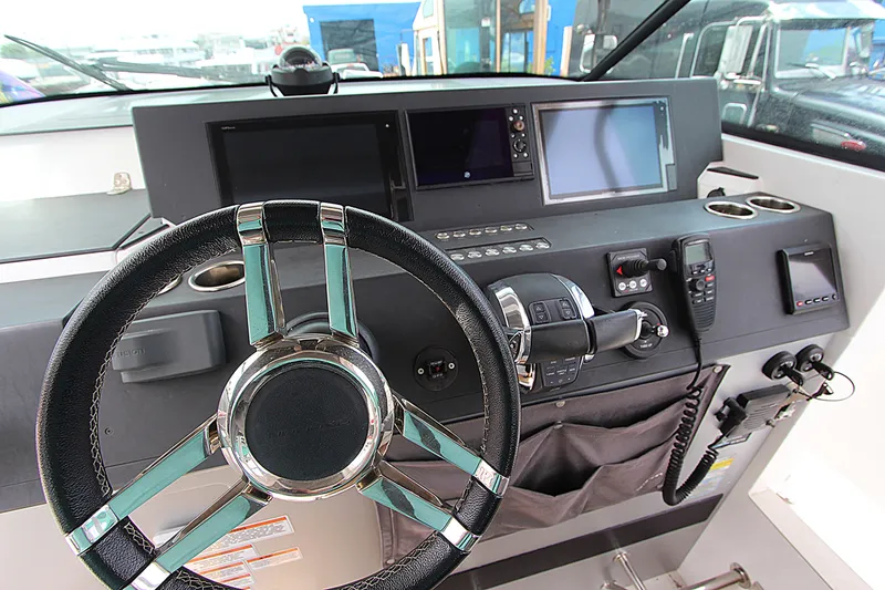 Slide: The Image of Steering console of 2018 Axopar 37 Sun-Top boat with modern navigation equipment. - 8